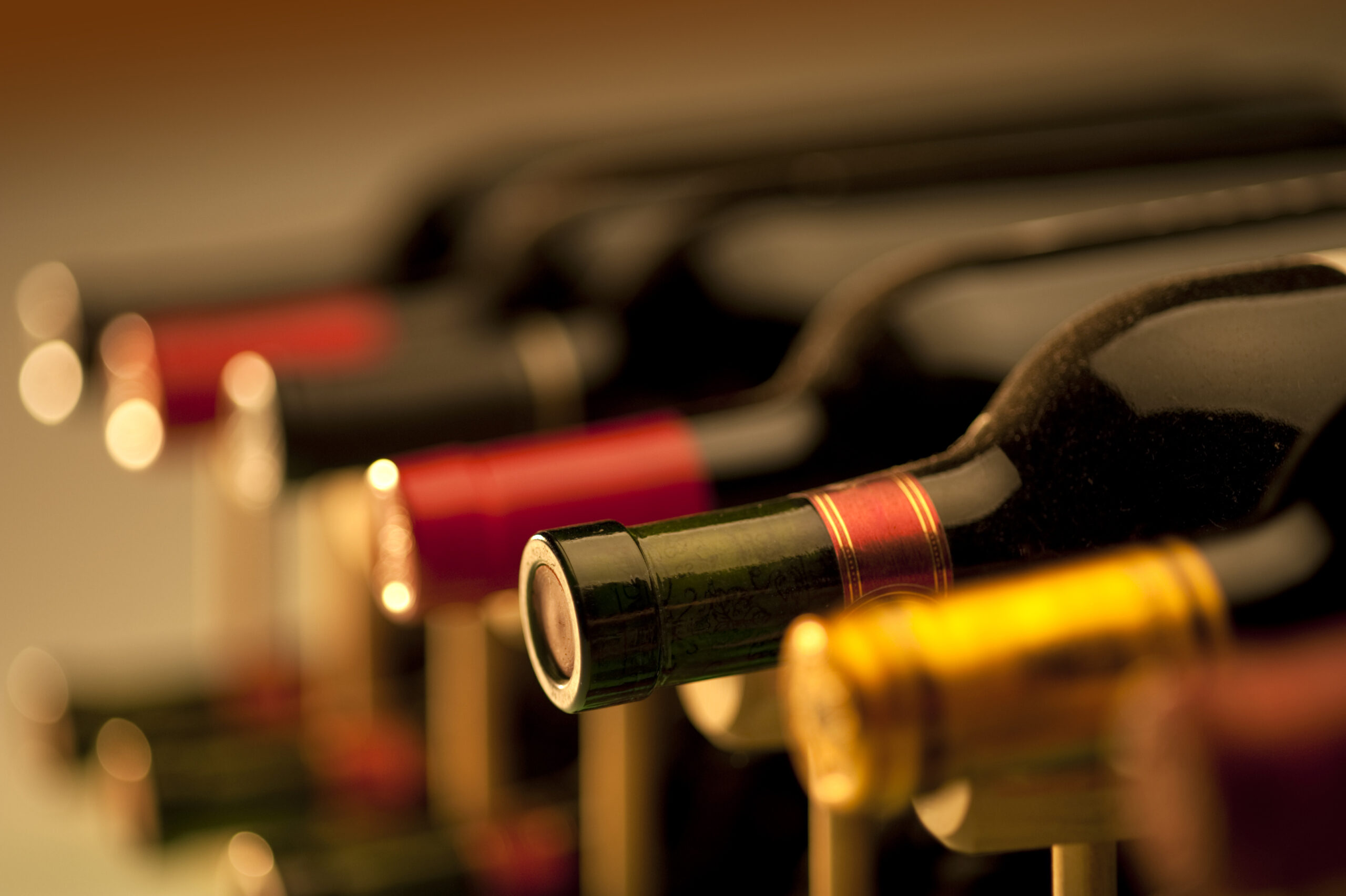 A close-up of several wine bottles with colorful caps, illustrating a curated selection for wine enthusiasts and highlighting product variety.